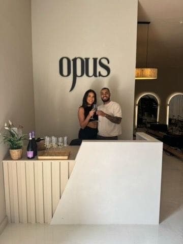 Opening day at Opus: a toast at the reception desk under the opus sign