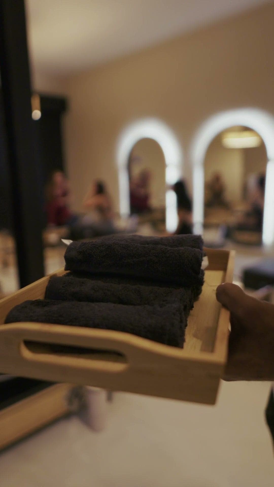 A tray of rolled towels being offered after class