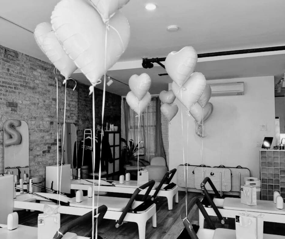 Heart balloons over the reformers, set up for a birthday class